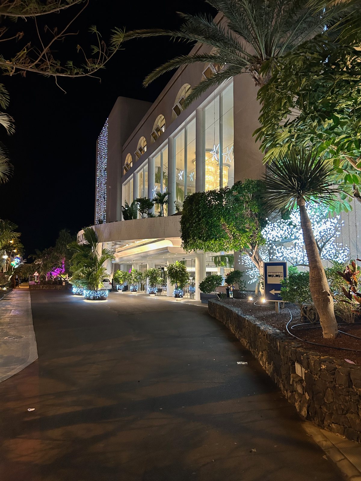 The Arona Gran exterior and planted walkway illuminated after dark