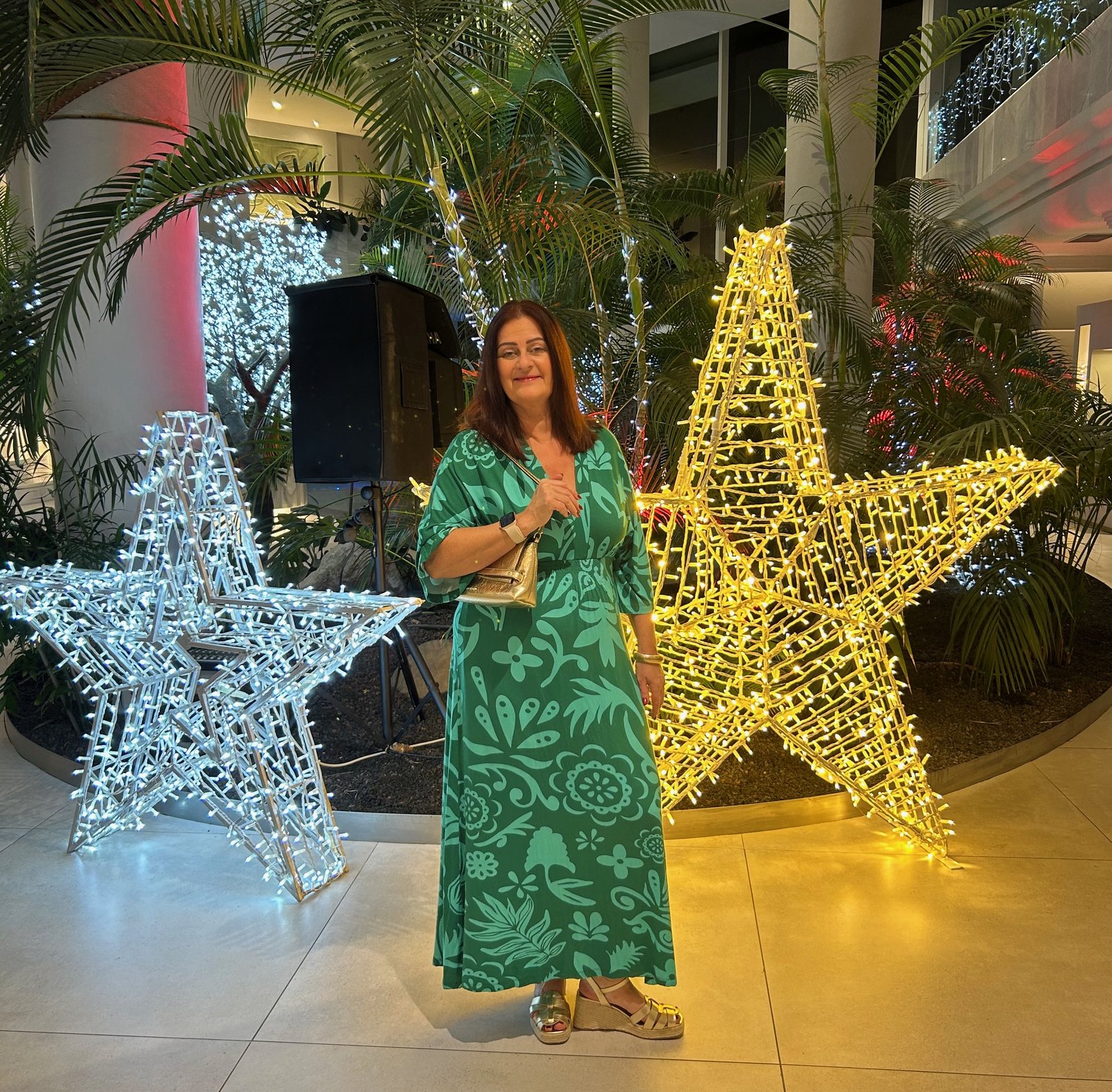Sarah beside illuminated gold and silver stars in the Arona Gran foyer