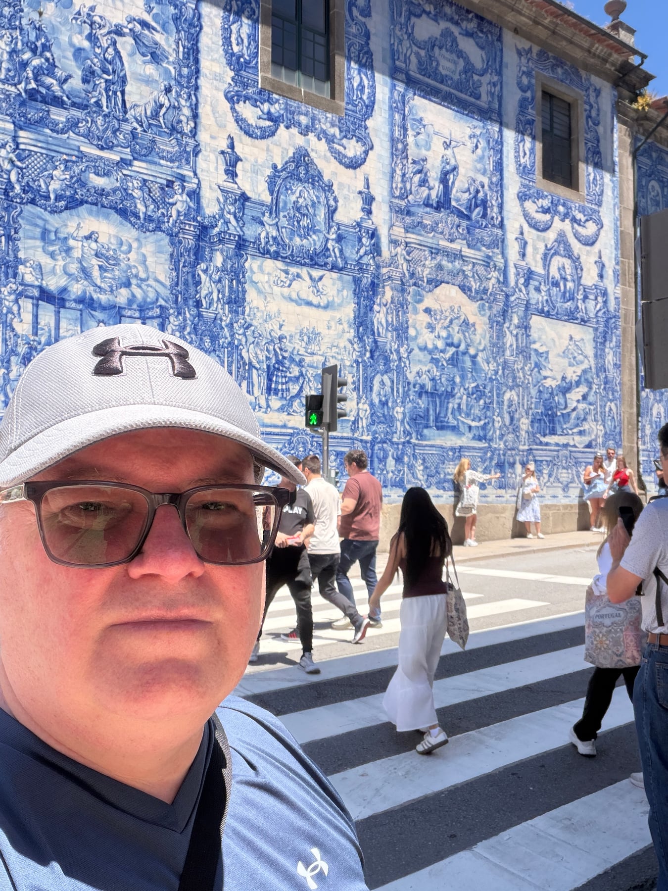 Chris in front of the blue tiled Capela das Almas in Porto