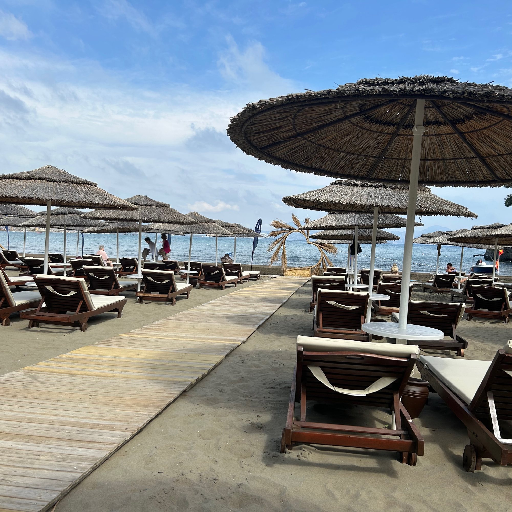 Comfortable sunbeds and parasols beside the hotel beach