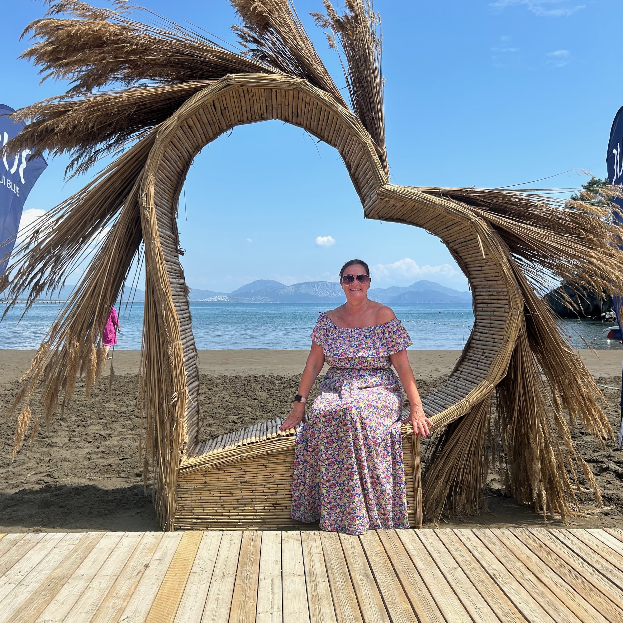 Sarah standing inside a heart-shaped beach sculpture