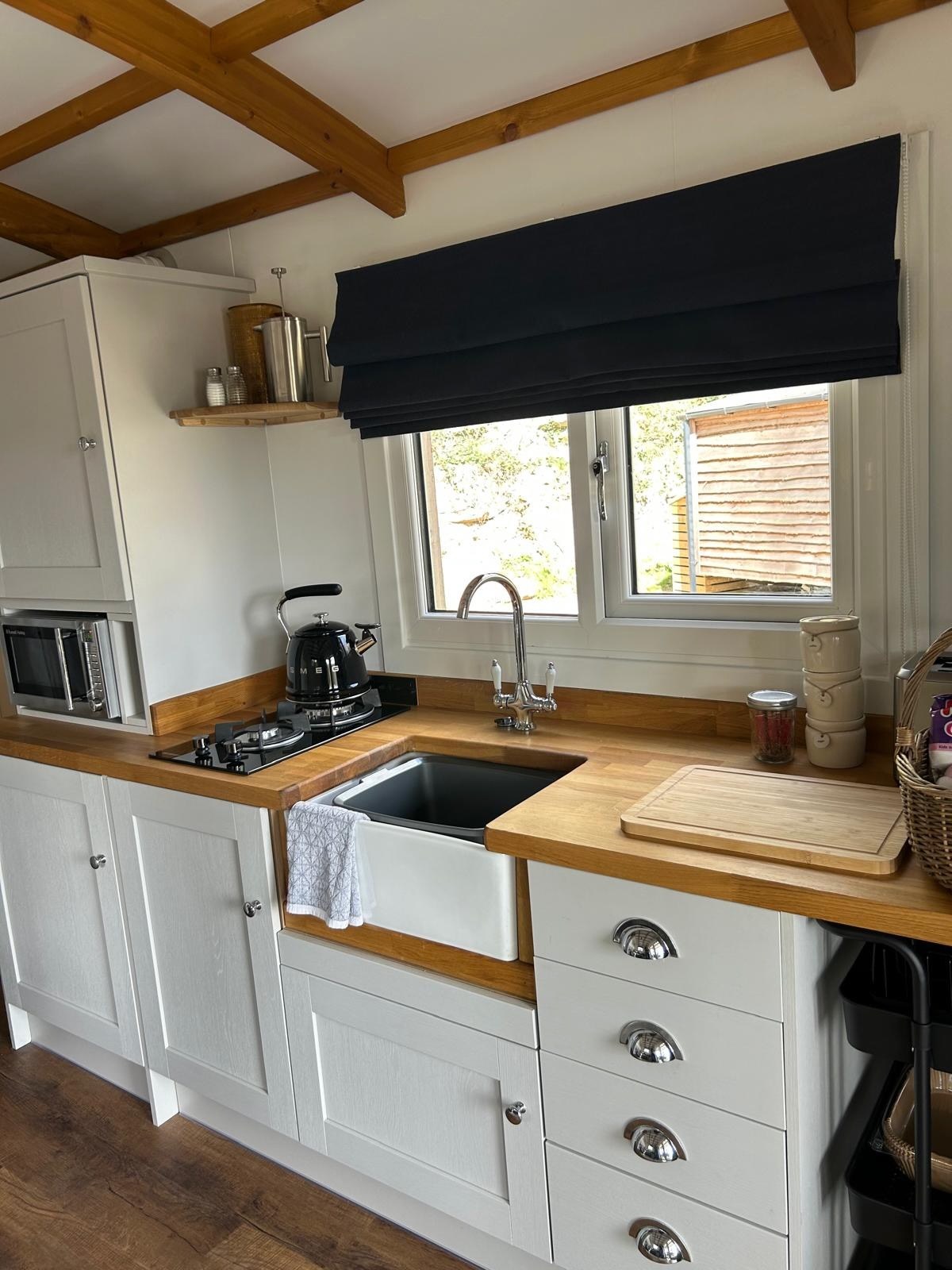The compact, well-equipped kitchen inside Sycamore Cabin